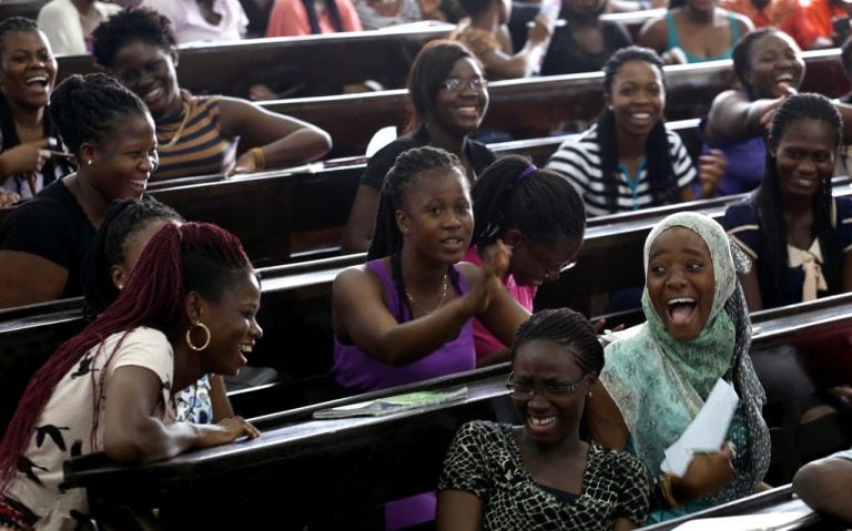 People attending a lively event or seminar, enjoying and laughing together.