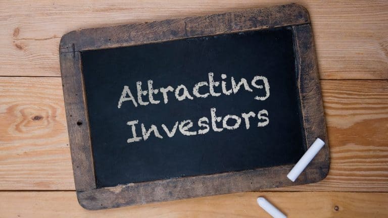 Attracting investors chalkboard sign for business growth and funding opportunities.