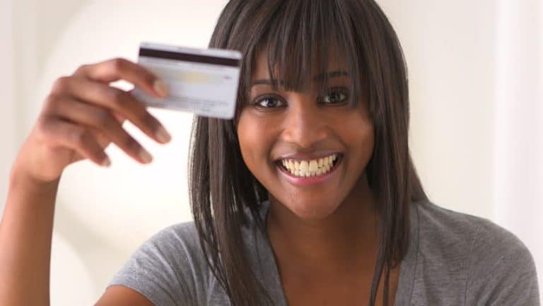 Credit card payment digital checkout woman smiling card transaction online shopping digital payment secure transaction online shopping experience safe online payments customer service business woman happy smiling woman holding credit card for online purchase.