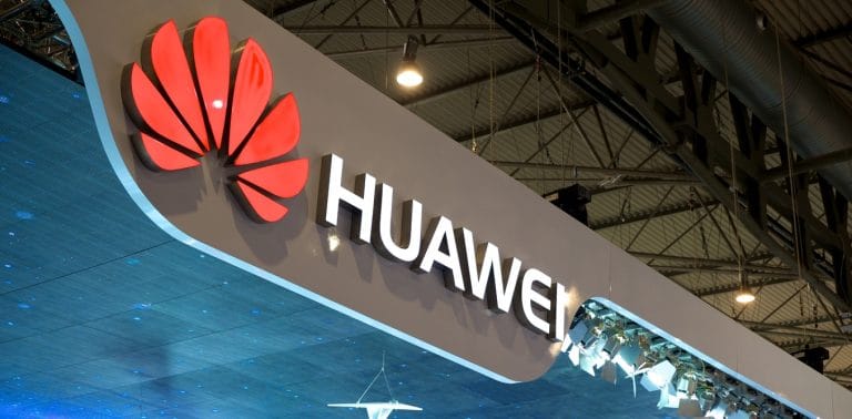 Huawei logo at technology trade show with prominent brand signage and modern industrial exhibition setup.