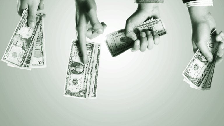 Stacks of US dollar bills being exchanged between hands with a pointing gesture, symbolizing financial transactions, money transfer, and cash flow management.